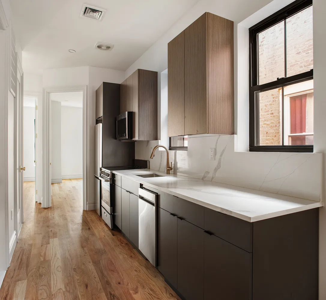 a kitchen with a sink cabinets and appliances