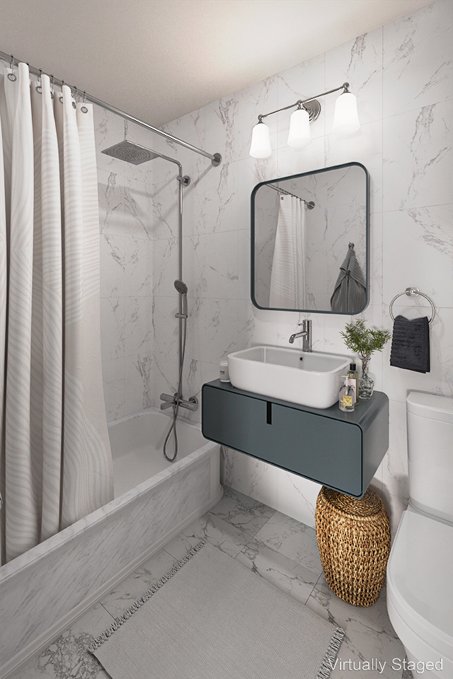 235 East 87th Street, Unit 8E Manhattan, NY 10128 - Photo 6 of 11 a bathroom with a tub sink and mirror