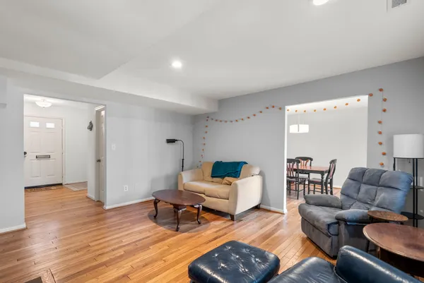 a living room with furniture and wooden floor