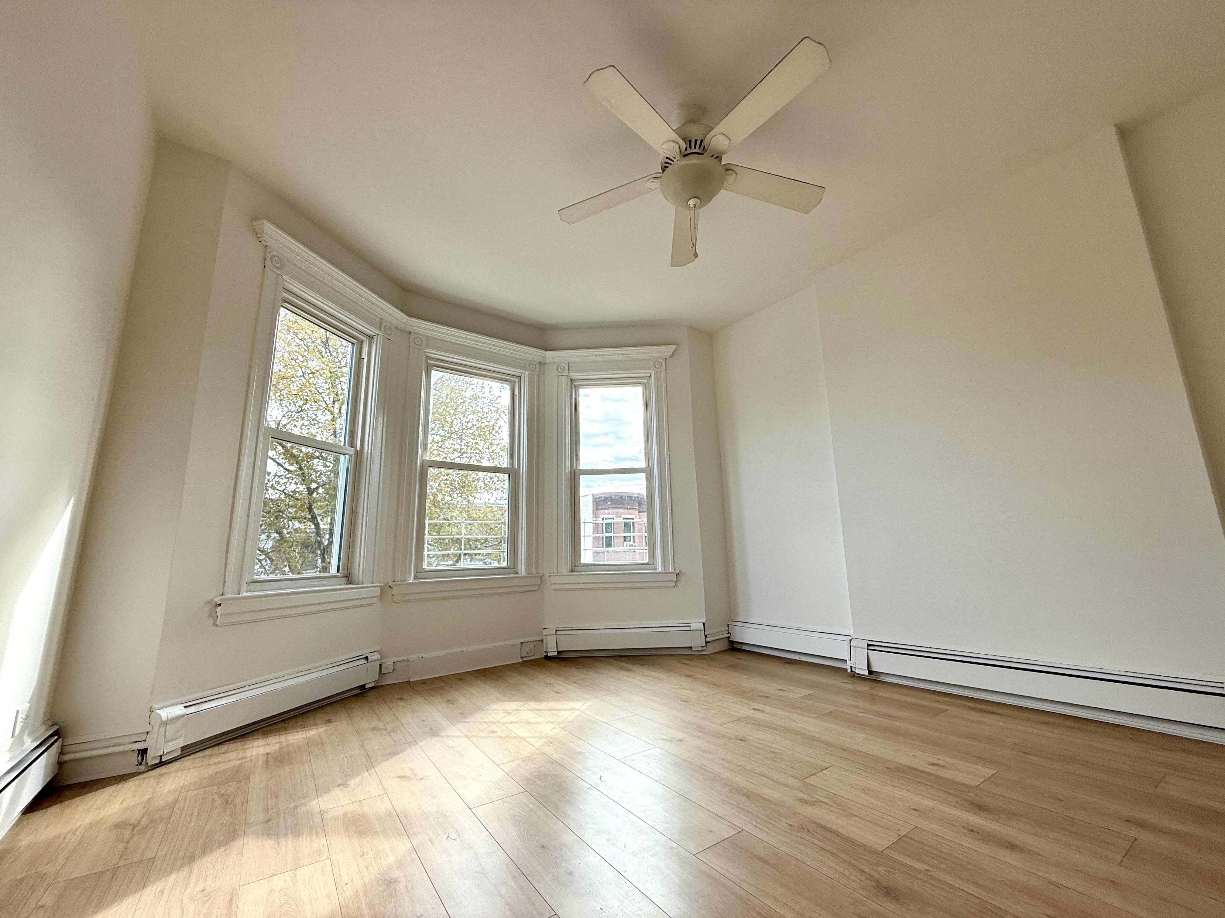31 Seeley Street, Unit Undisclosed Brooklyn, NY 11218 - Photo 1 of 31 an empty room with wooden floor and windows