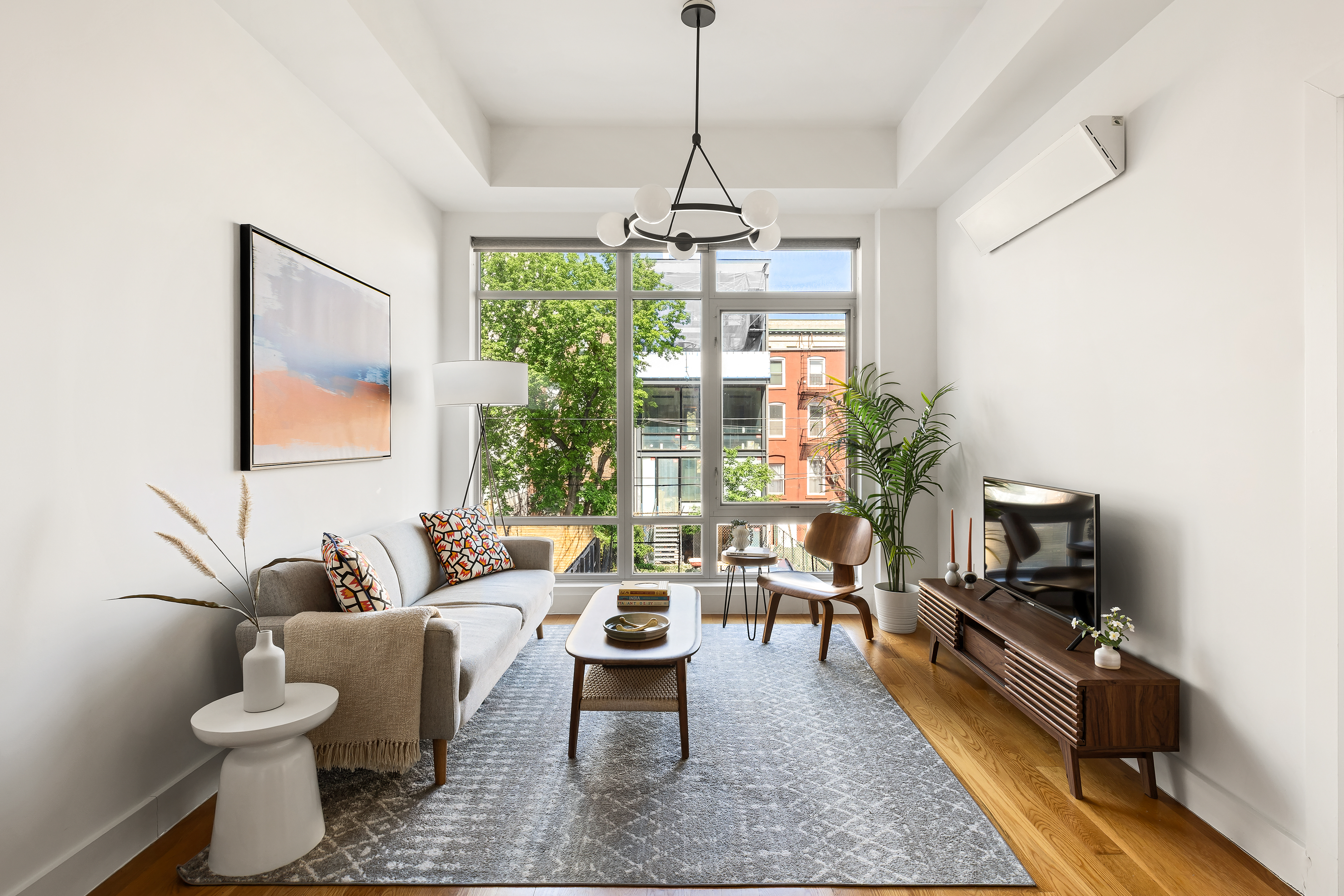 659 Bergen Street, Unit 2D Brooklyn, NY 11238 - Photo 2 of 9 a living room with furniture and a flat screen tv