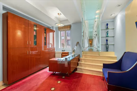 a living room with furniture a large window with wooden floor