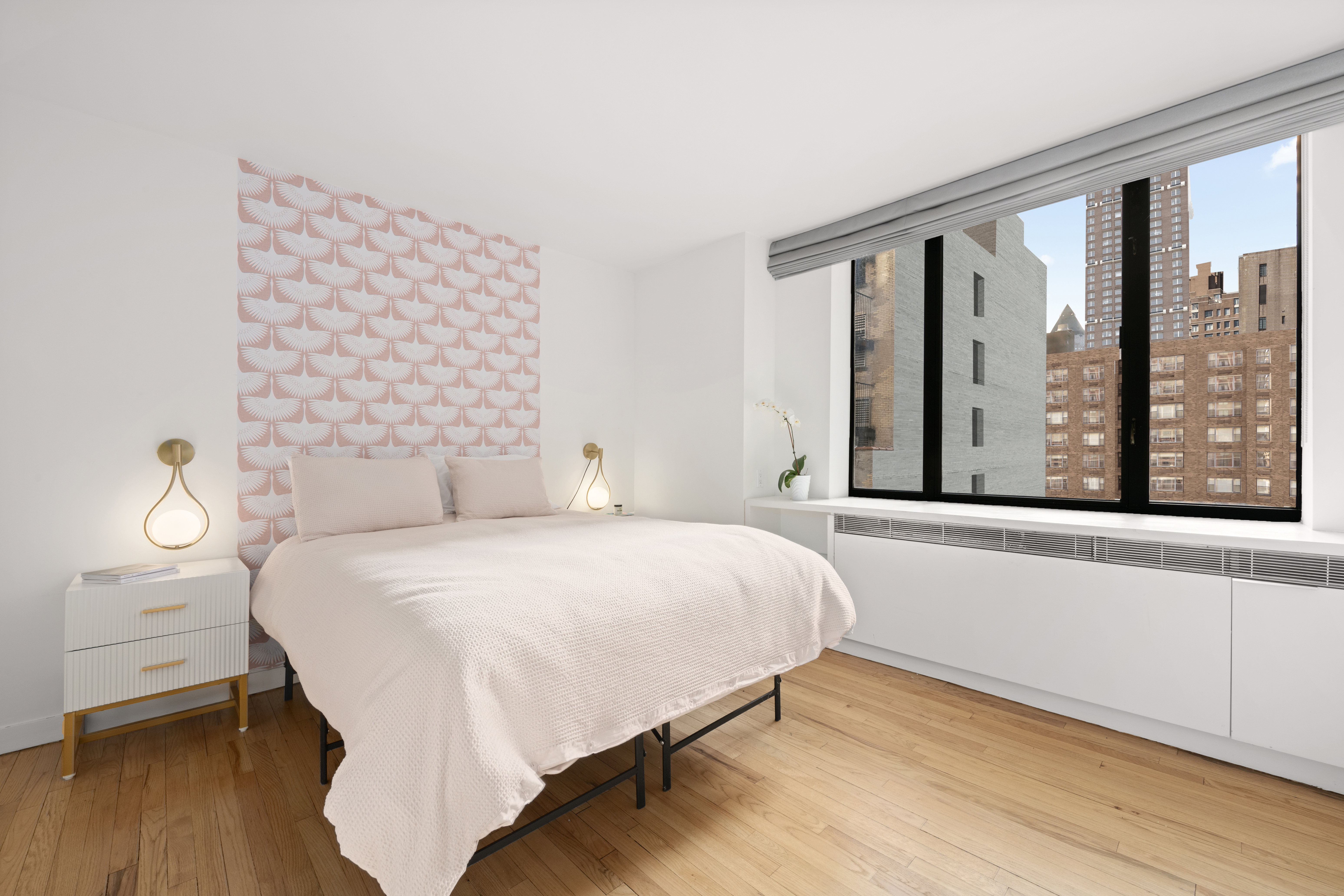 30 West 61st Street, Unit 9C Manhattan, NY 10023 - Photo 5 of 10 a bedroom with a bed and a large window with outer view