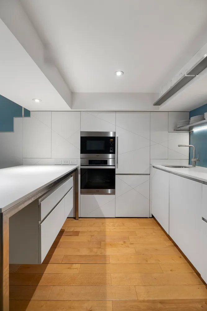 a kitchen with stainless steel appliances a stove and more cabinets