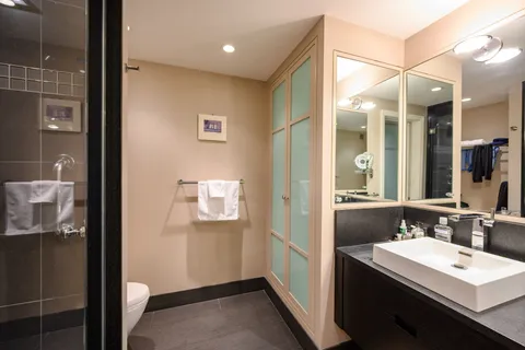 a en suite bathroom with a sink a mirror and a shower