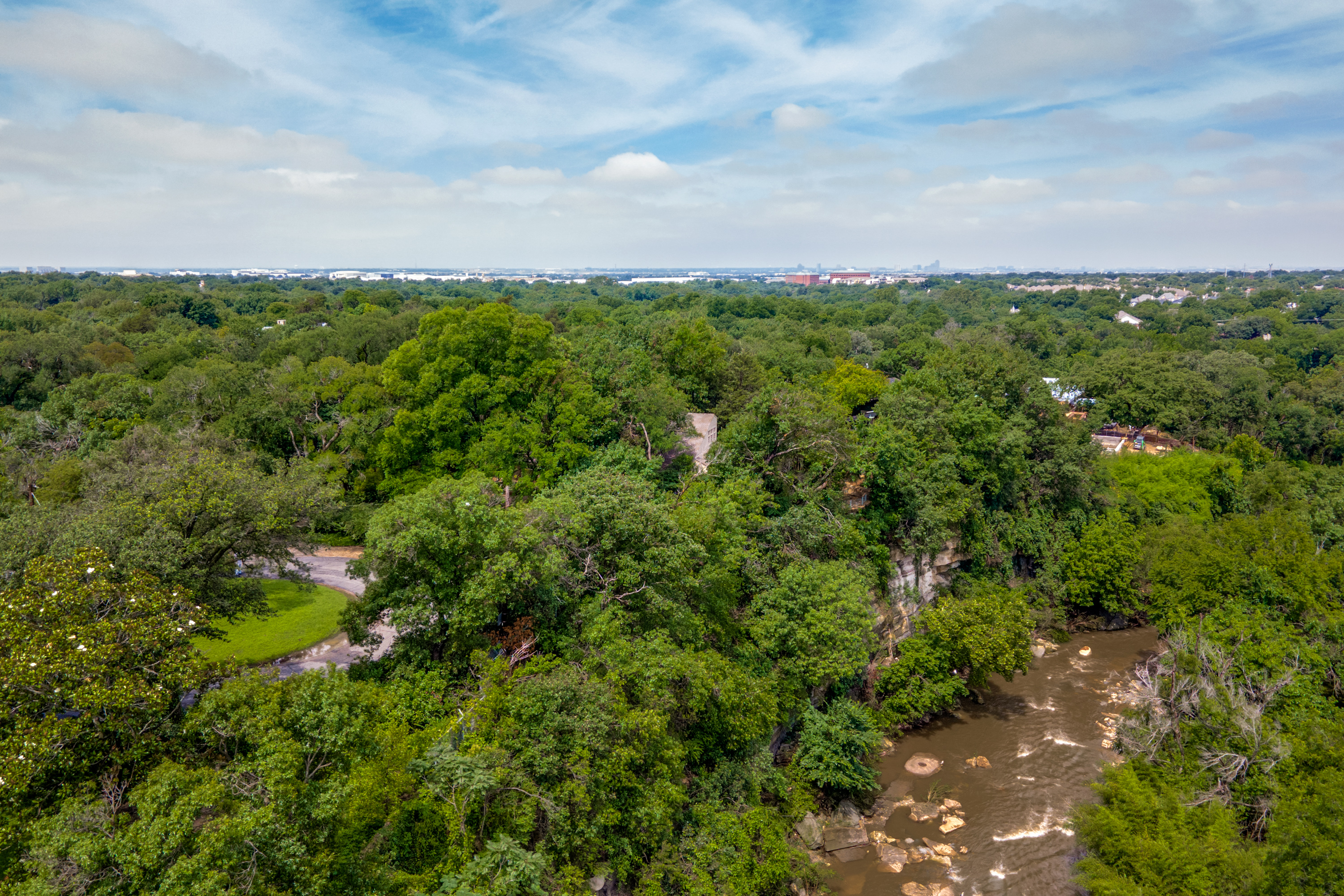 4811 Bluffview Boulevard Dallas, TX 75209 - Photo 2 of 3 a view of a big yard with lots of green space and trampoline