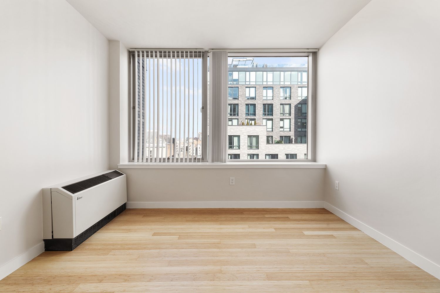40 West 116th Street, Unit A808 Manhattan, NY 10026 - Photo 4 of 19 an empty room with wooden floor and windows