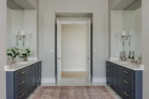 a bathroom with a granite countertop sink a mirror and a shower