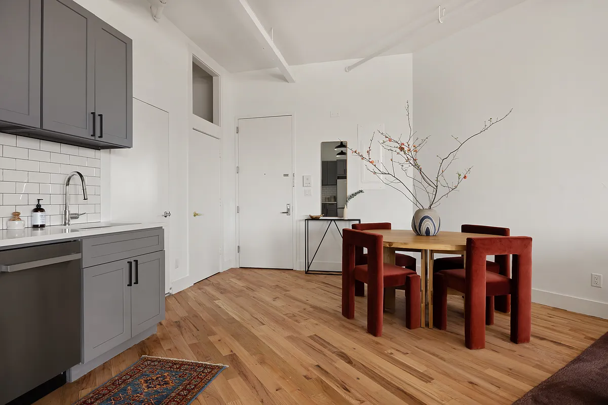 239 Banker Street, Unit 4K Brooklyn, NY 11222 - Photo 8 of 13 a open kitchen with stainless steel appliances granite countertop a sink dishwasher a stove with wooden cabinets and floor