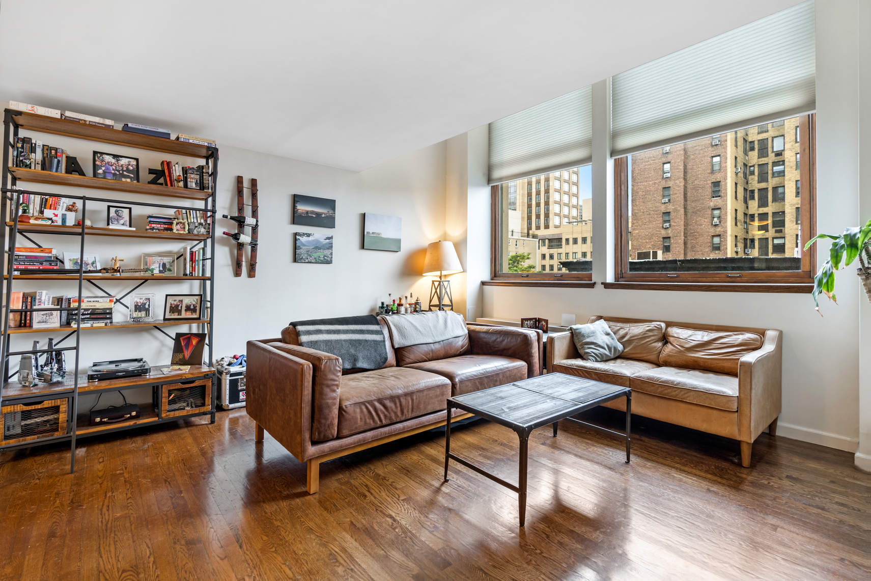 305 2nd Avenue, Unit 518 Manhattan, NY 10003 - Photo 1 of 19 a living room with furniture and a book shelf