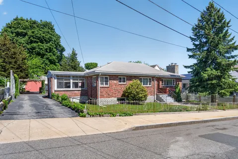 a front view of house with yard and green space