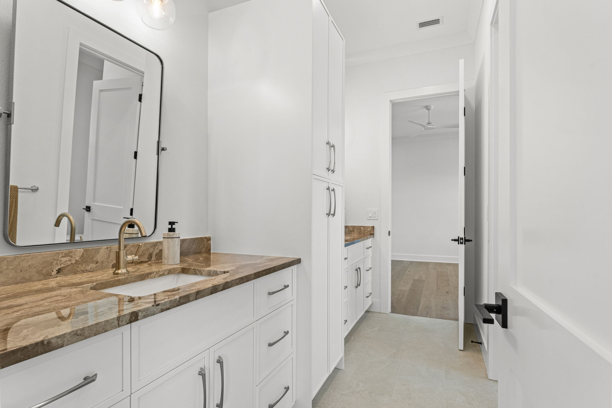 500 East Davis Boulevard Tampa, FL 33606 - Photo 25 of 36 a bathroom with a granite countertop sink and a mirror