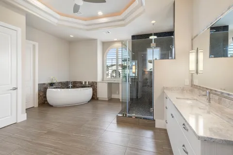 a large kitchen with stainless steel appliances granite countertop a sink a stove and a refrigerator