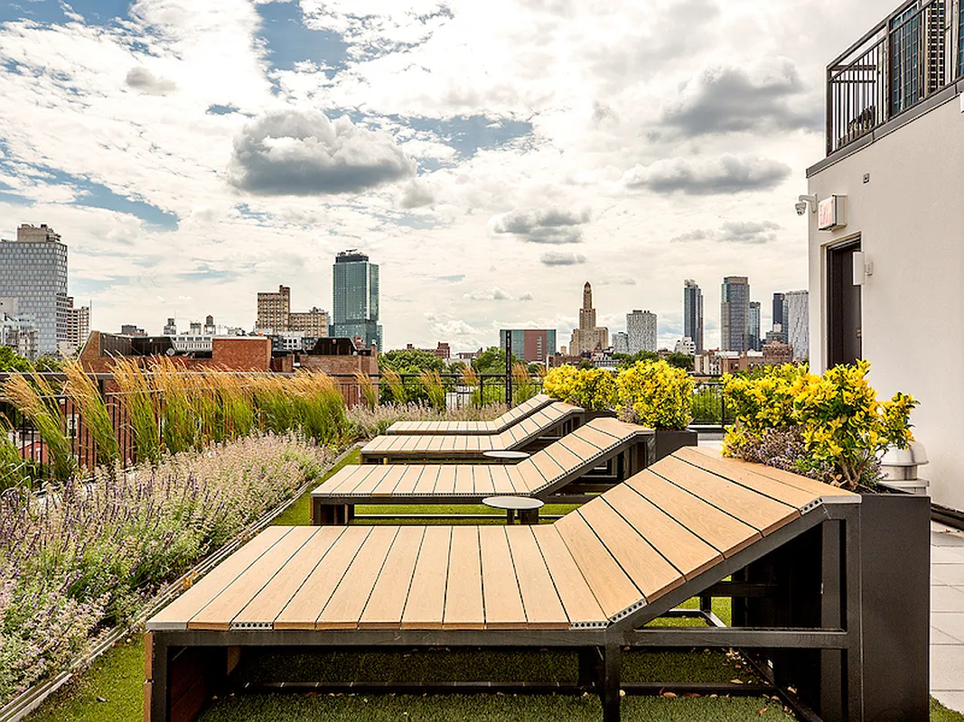 10 Quincy Street, Unit 1H Brooklyn, NY 11238 - Photo 11 of 15 a view of a roof deck with chair and wooden floor