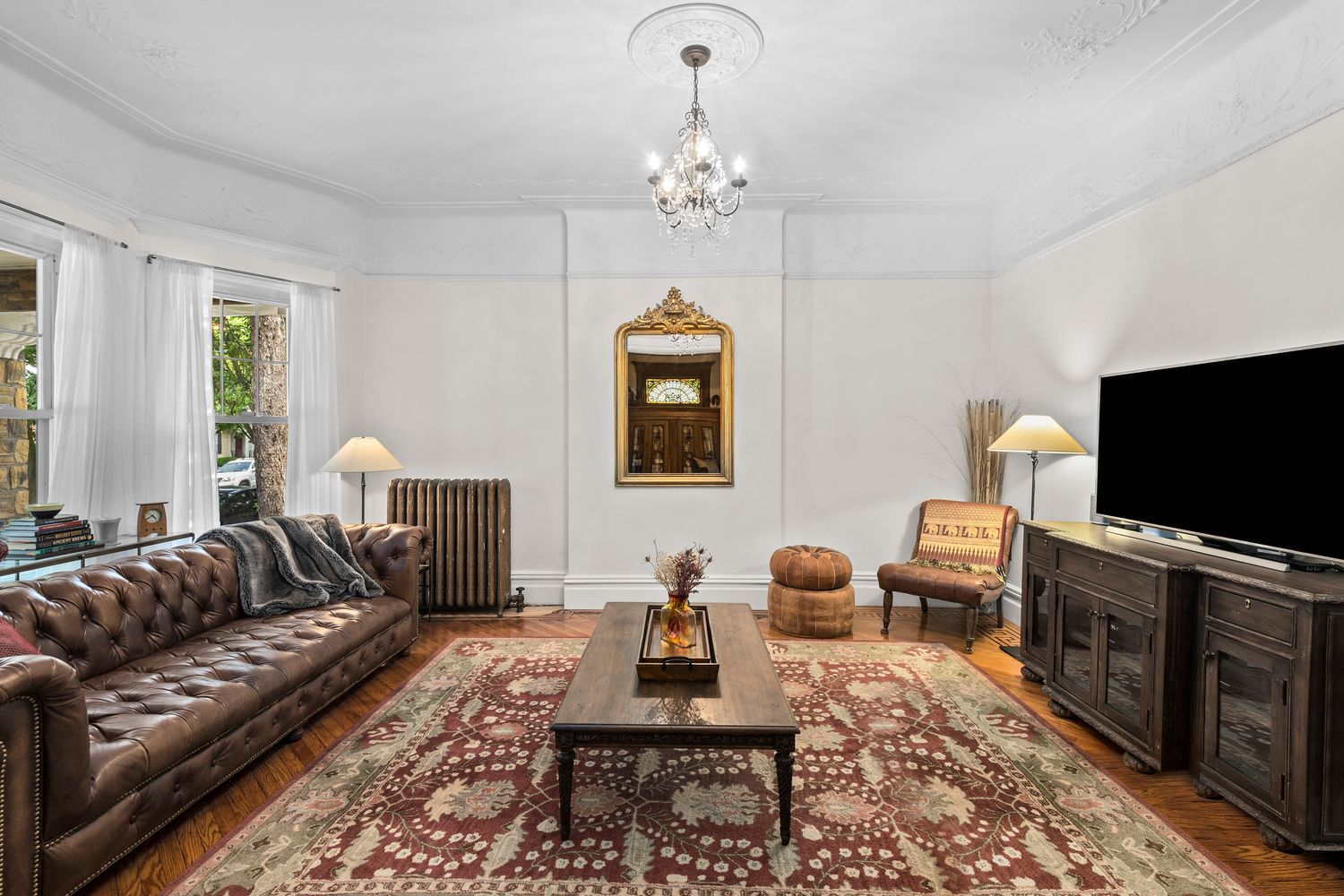 685 East 22nd Street Brooklyn, NY 11210 - Photo 7 of 43 a living room with furniture a flat screen tv and a chandelier