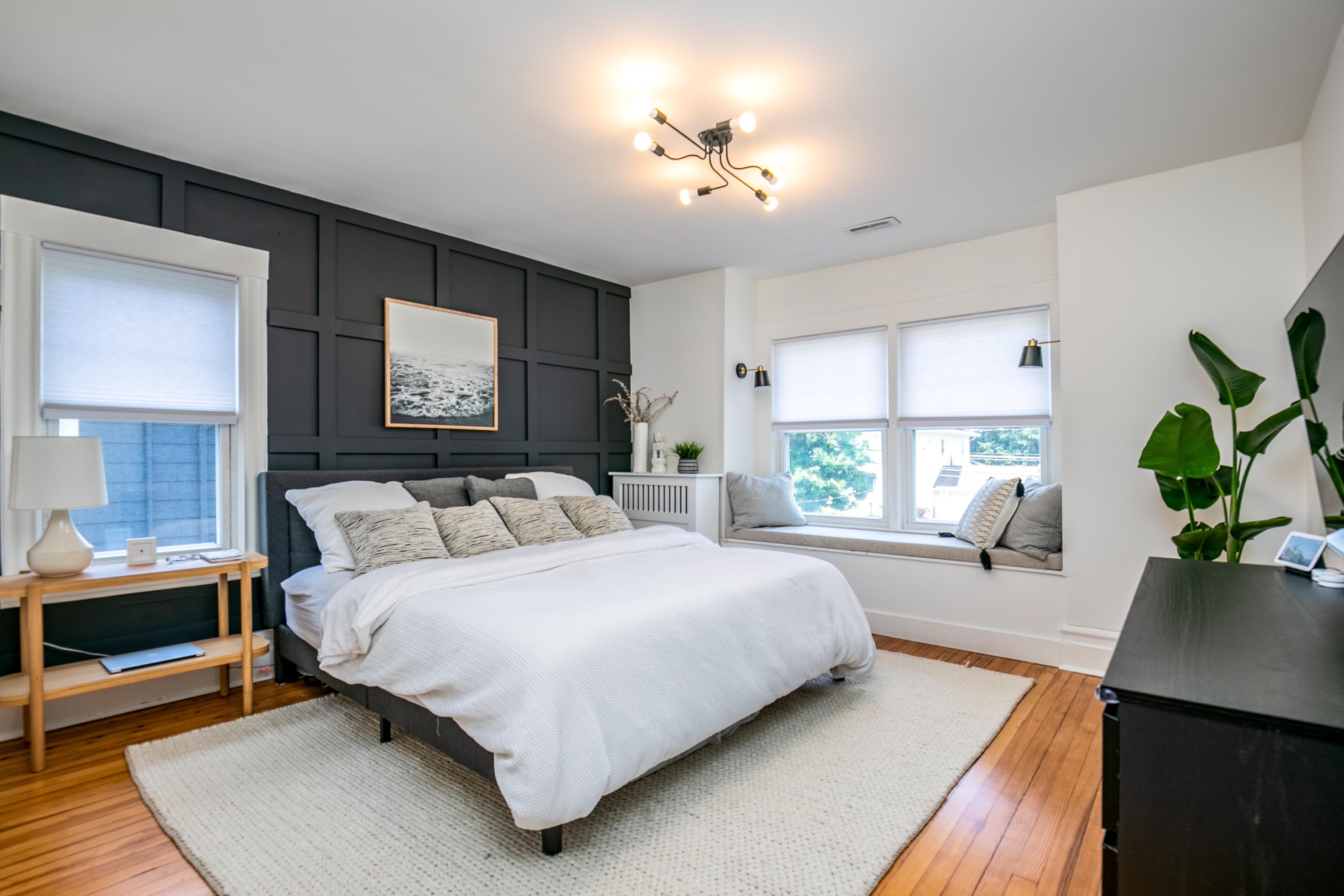 163 Ridge Road Rutherford, NJ 07070 - Photo 31 of 59 a bedroom with a bed a potted plant on dresser and a wooden floor