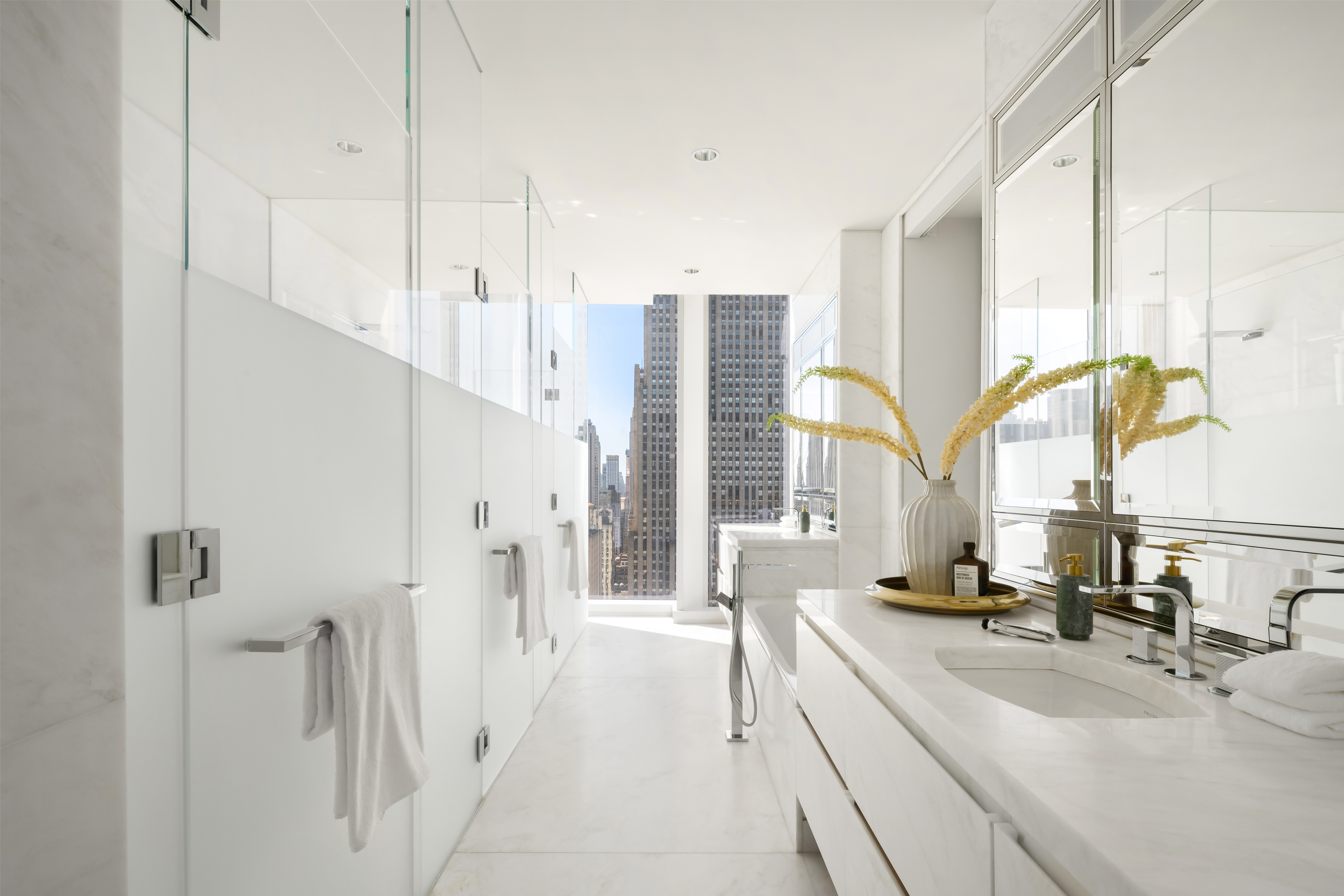 20 West 53rd Street, Unit 4243A Manhattan, NY 10019 - Photo 12 of 30 a bathroom with a double vanity sink and a bathtub
