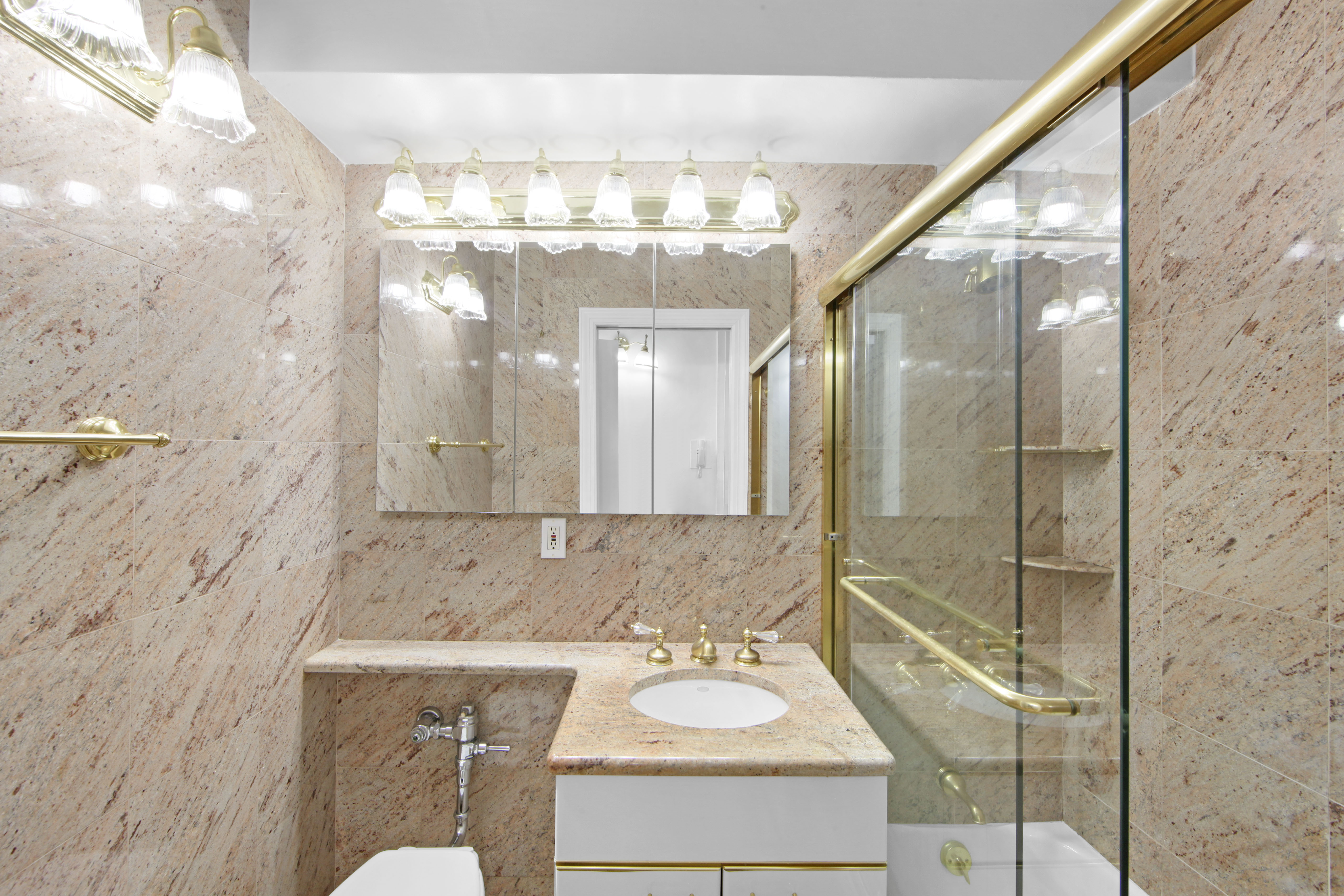 404 East 66th Street, Unit 11B Manhattan, NY 10065 - Photo 7 of 9 a bathroom with a double vanity sink mirror and shower