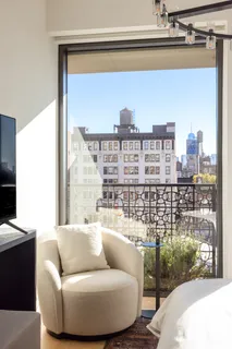 a living room with furniture and a floor to ceiling window