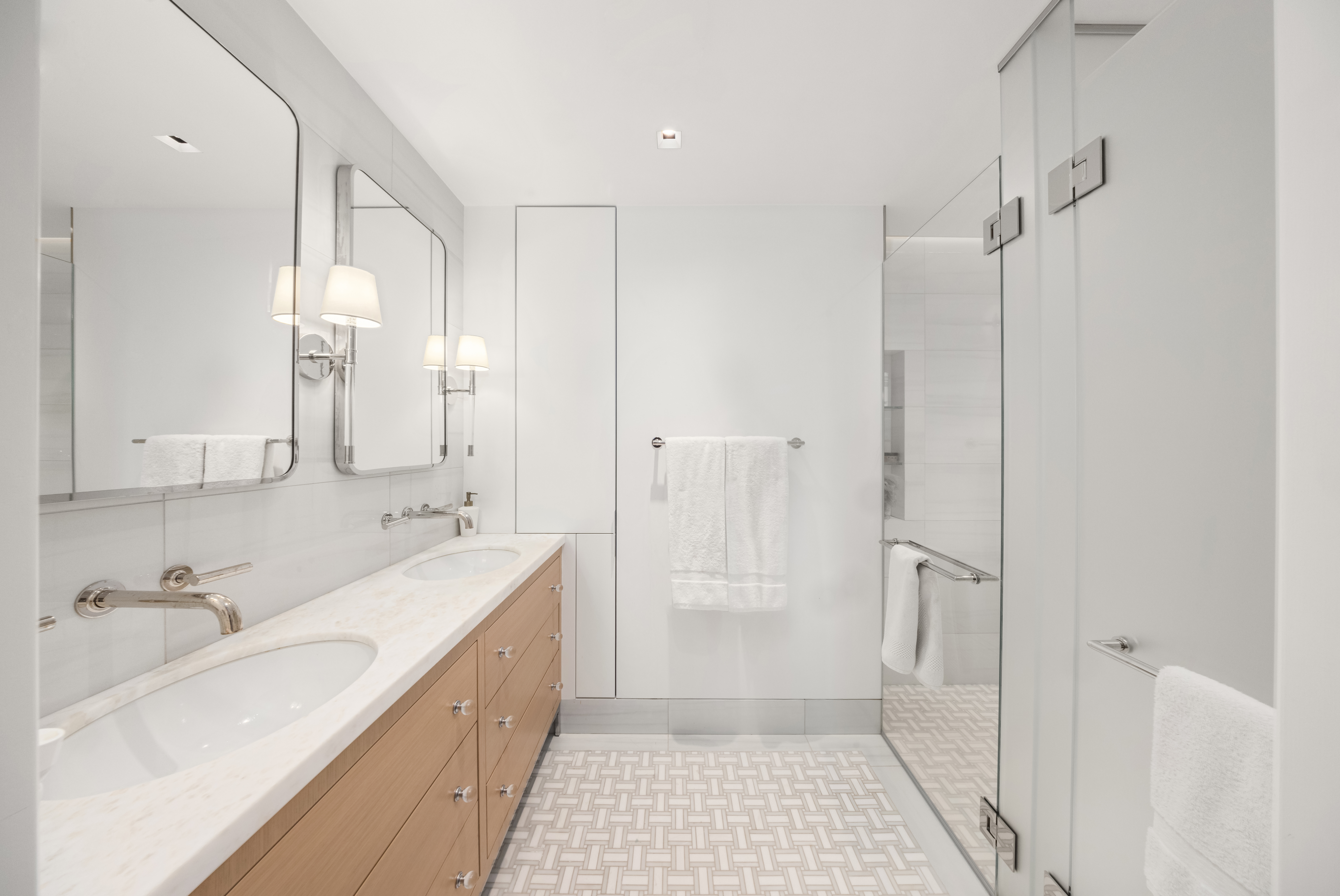 150 East 69th Street, Unit 18S Manhattan, NY 10021 - Photo 13 of 16 a bathroom with a double vanity sink a mirror and a shower