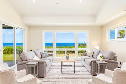 a living room with furniture and large windows