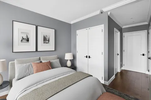 a bedroom with a bed and a painting on the wall