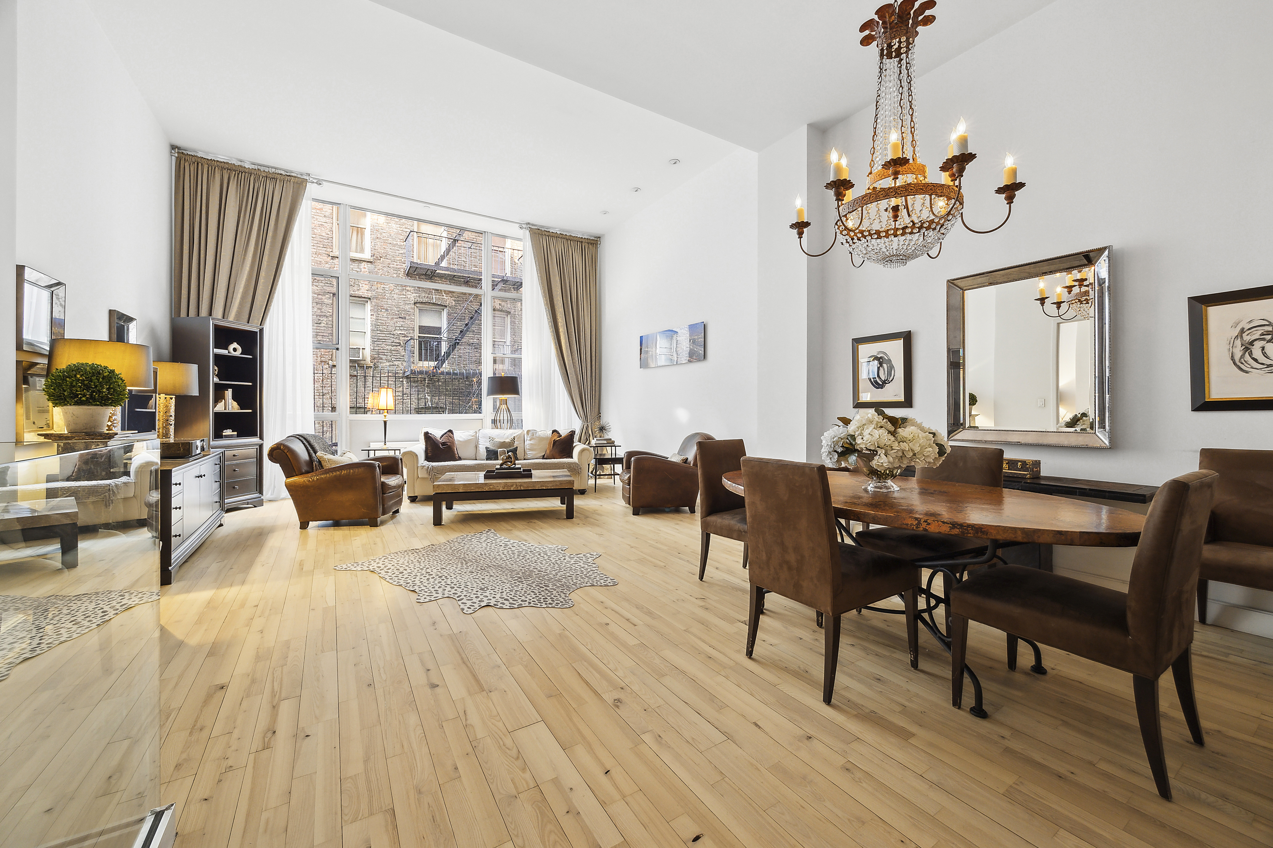 420 West 25th Street, Unit TH1E Manhattan, NY 10001 - Photo 4 of 22 a view of a dining room with furniture window and wooden floor