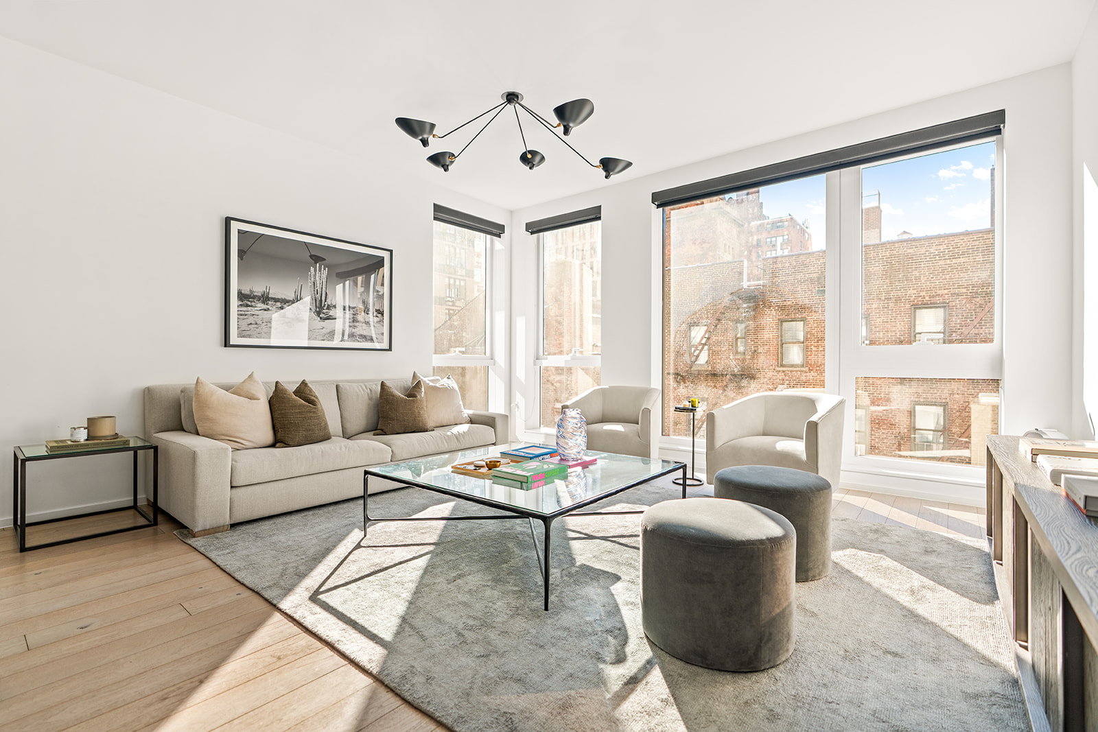 150 East 23rd Street, Unit 5D Manhattan, NY 10010 - Photo 1 of 12 a living room with furniture and a large window