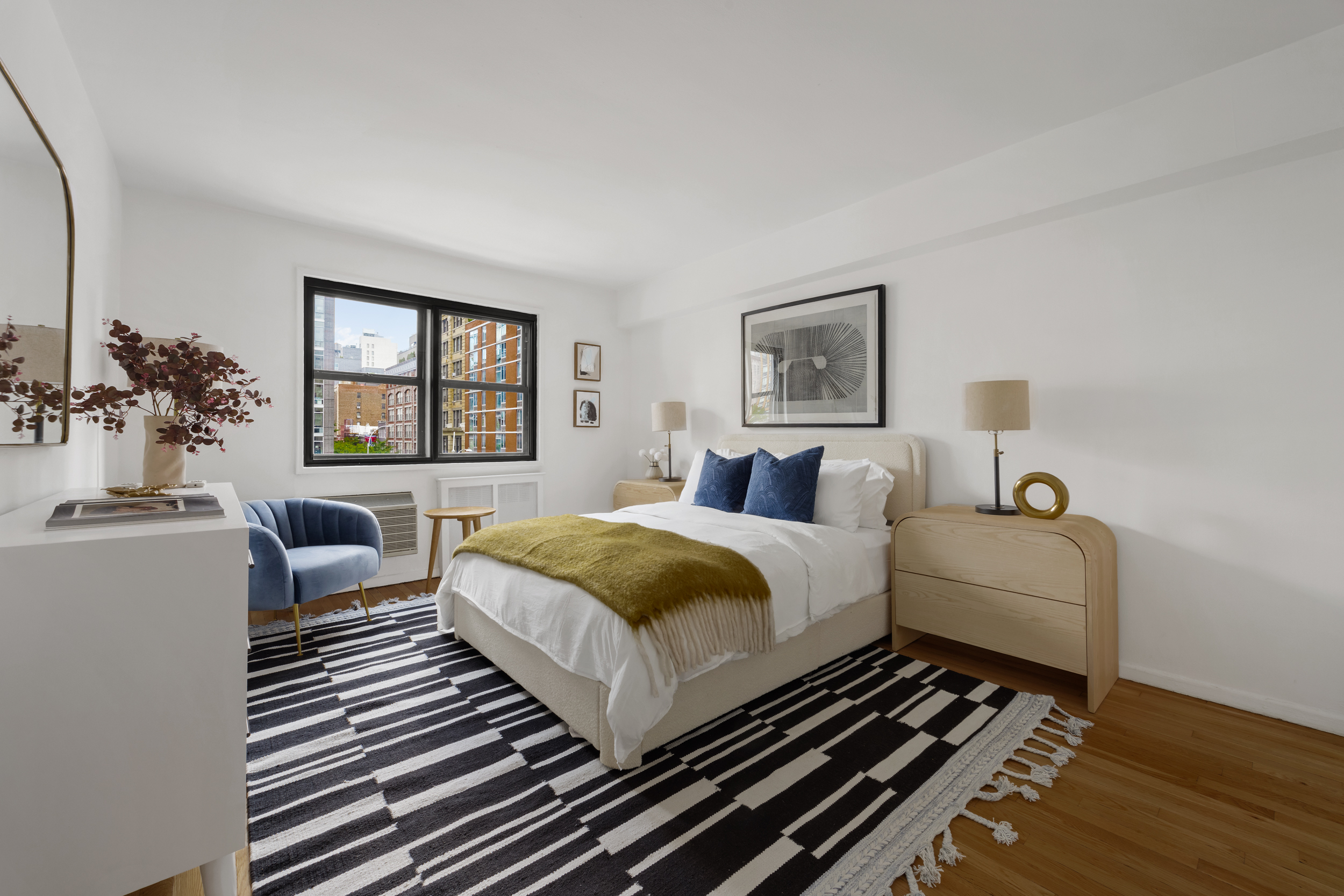 140 7th Avenue, Unit 4L Manhattan, NY 10011 - Photo 12 of 14 a bedroom with a bed and wooden floor