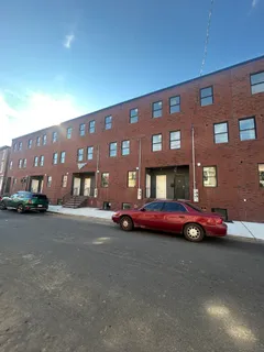 a front view of a building with parking space