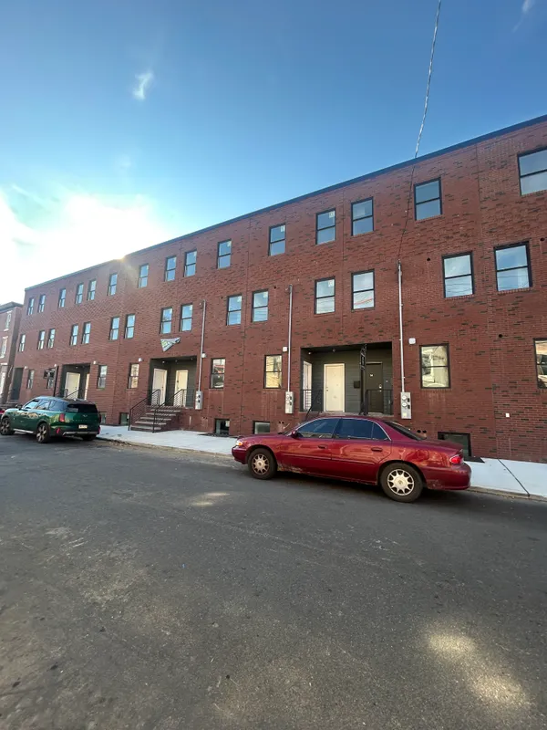 a front view of a building with parking space