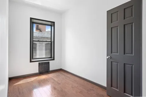an empty room with windows and closet