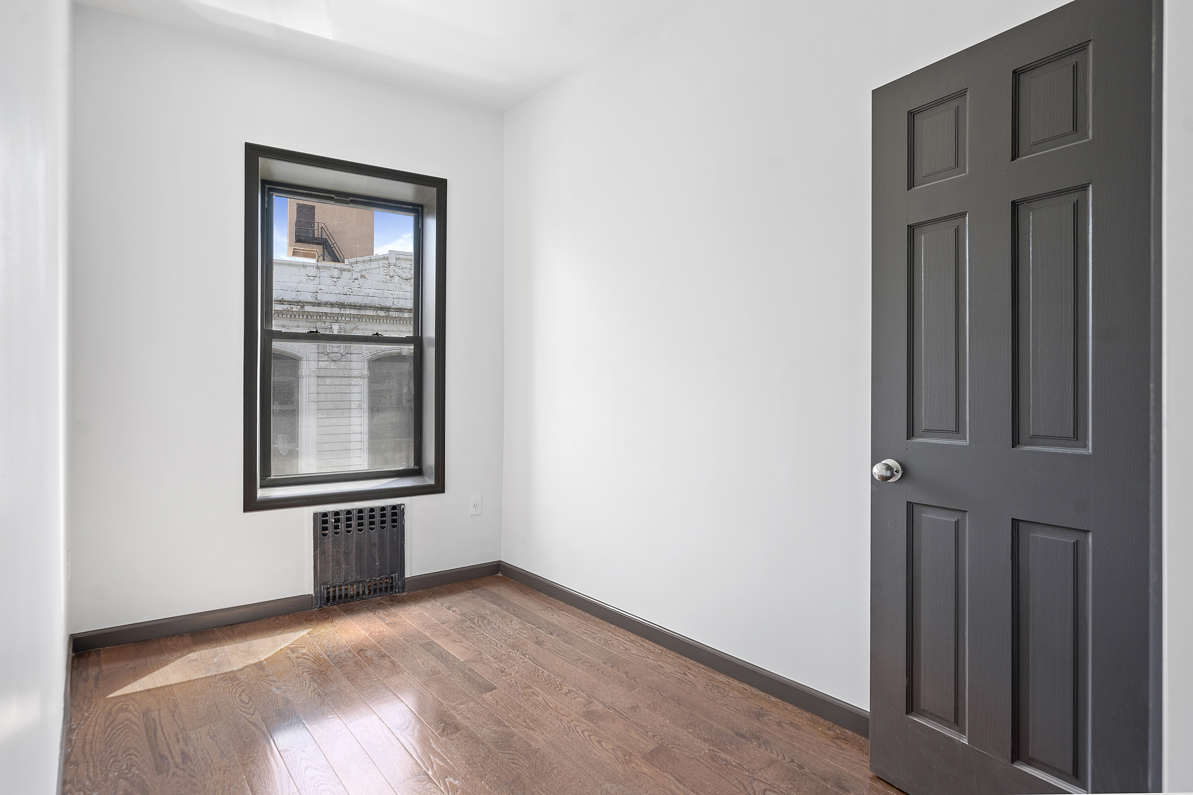 1389 Fulton Street, Unit 3 Brooklyn, NY 11216 - Photo 9 of 12 an empty room with windows and closet