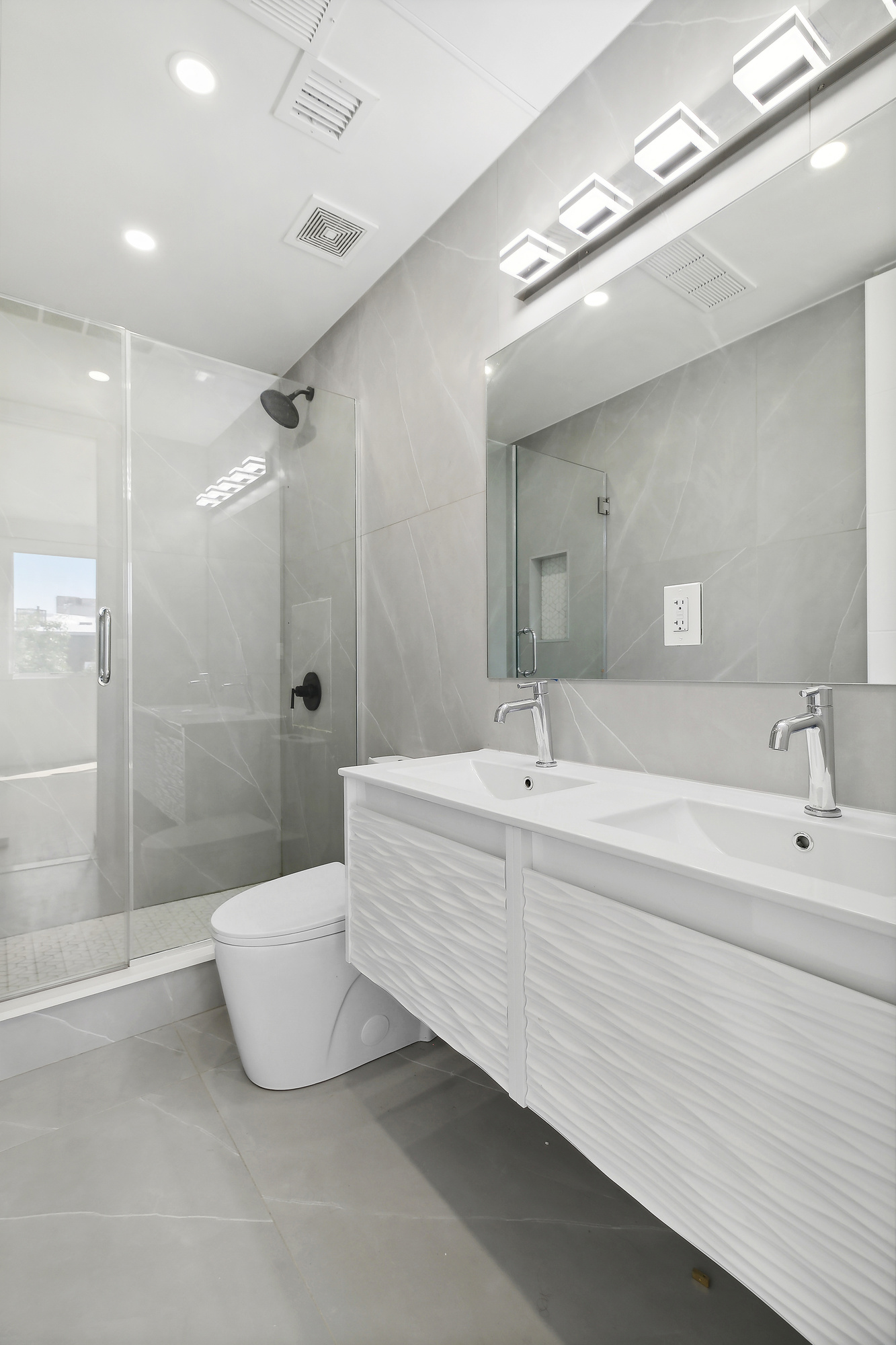 483 Hart Street, Unit 1 Brooklyn, NY 11221 - Photo 9 of 18 a spacious bathroom with a bathtub double sink and shower
