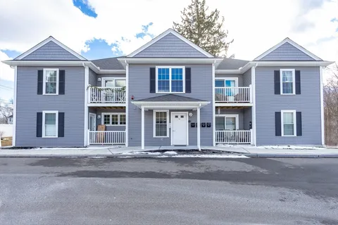 a front view of a house with a yard and outdoor seating