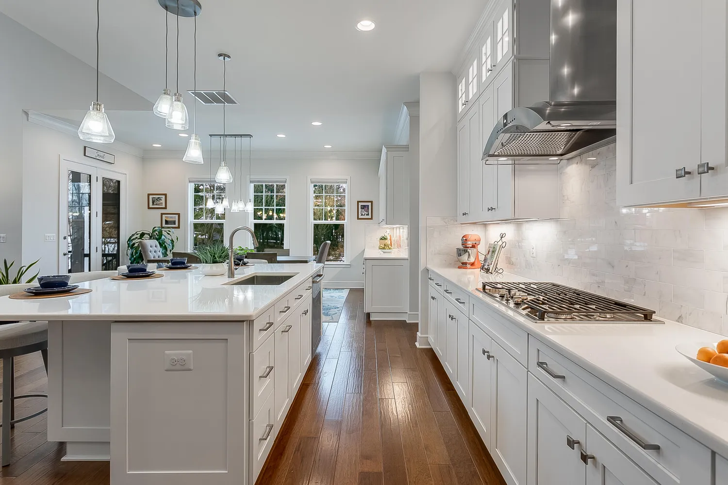 a kitchen with kitchen island stainless steel appliances a sink stove and cabinets