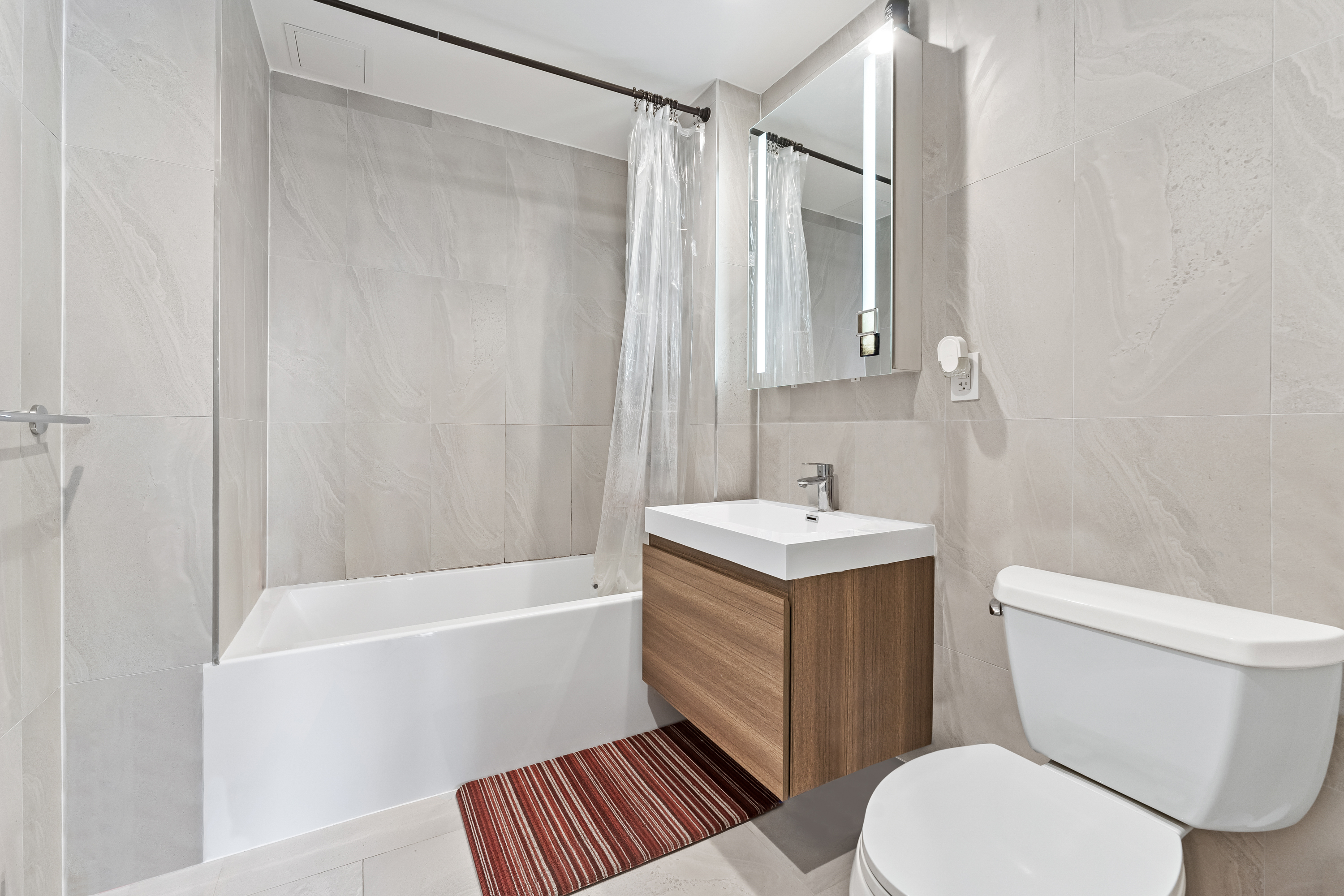 14-33 31st Avenue, Unit H5 Queens, NY 11106 - Photo 5 of 10 a bathroom with a sink toilet and shower