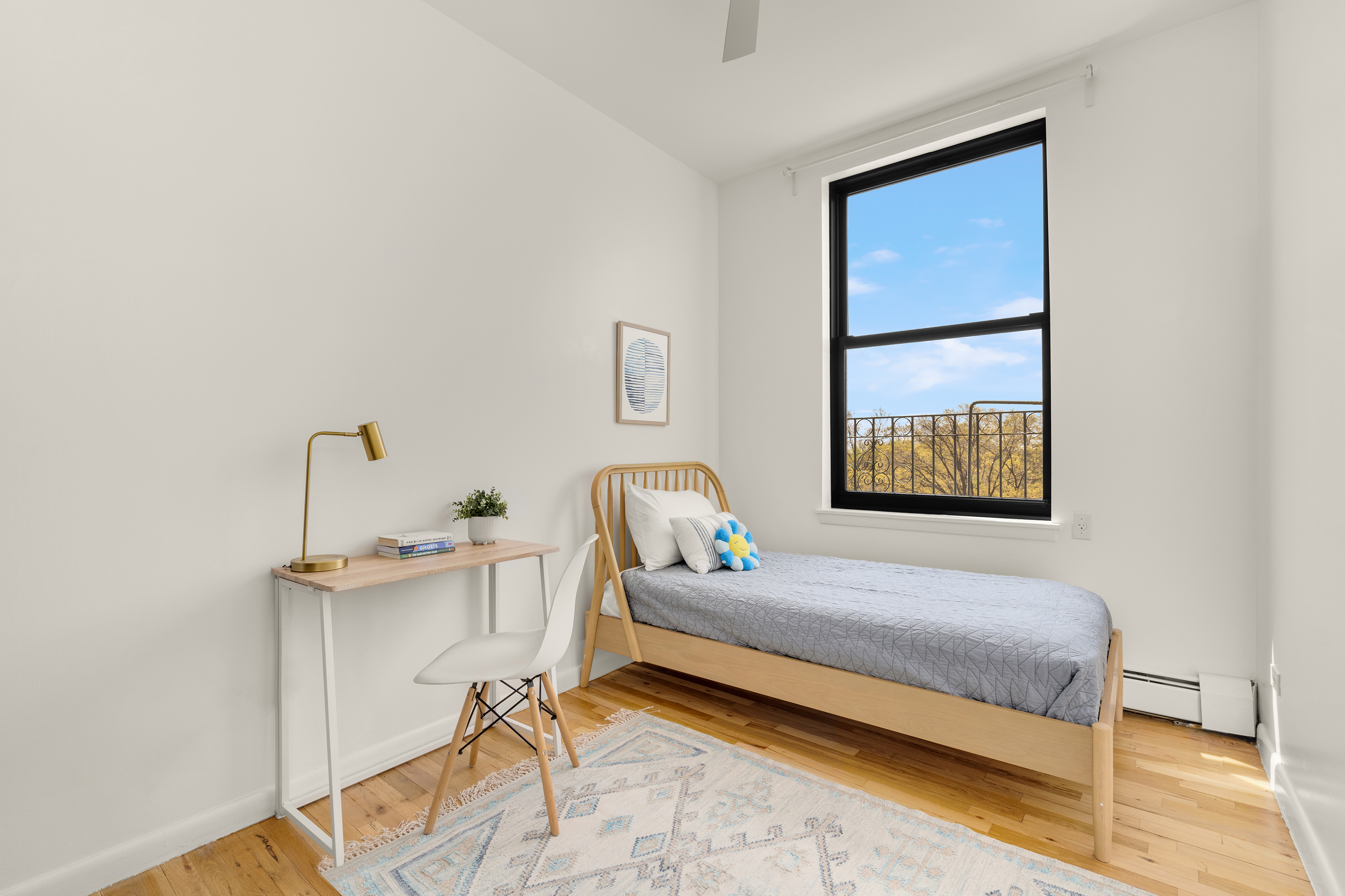 115 Eastern Parkway, Unit 6F Brooklyn, NY 11238 - Photo 6 of 11 a bedroom with a bed and a table in it