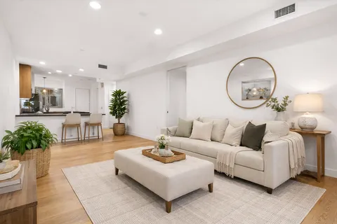 a living room with furniture and a chandelier