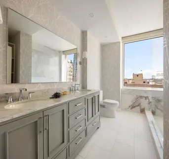 a bathroom with a double vanity sink toilet mirror and bathtub