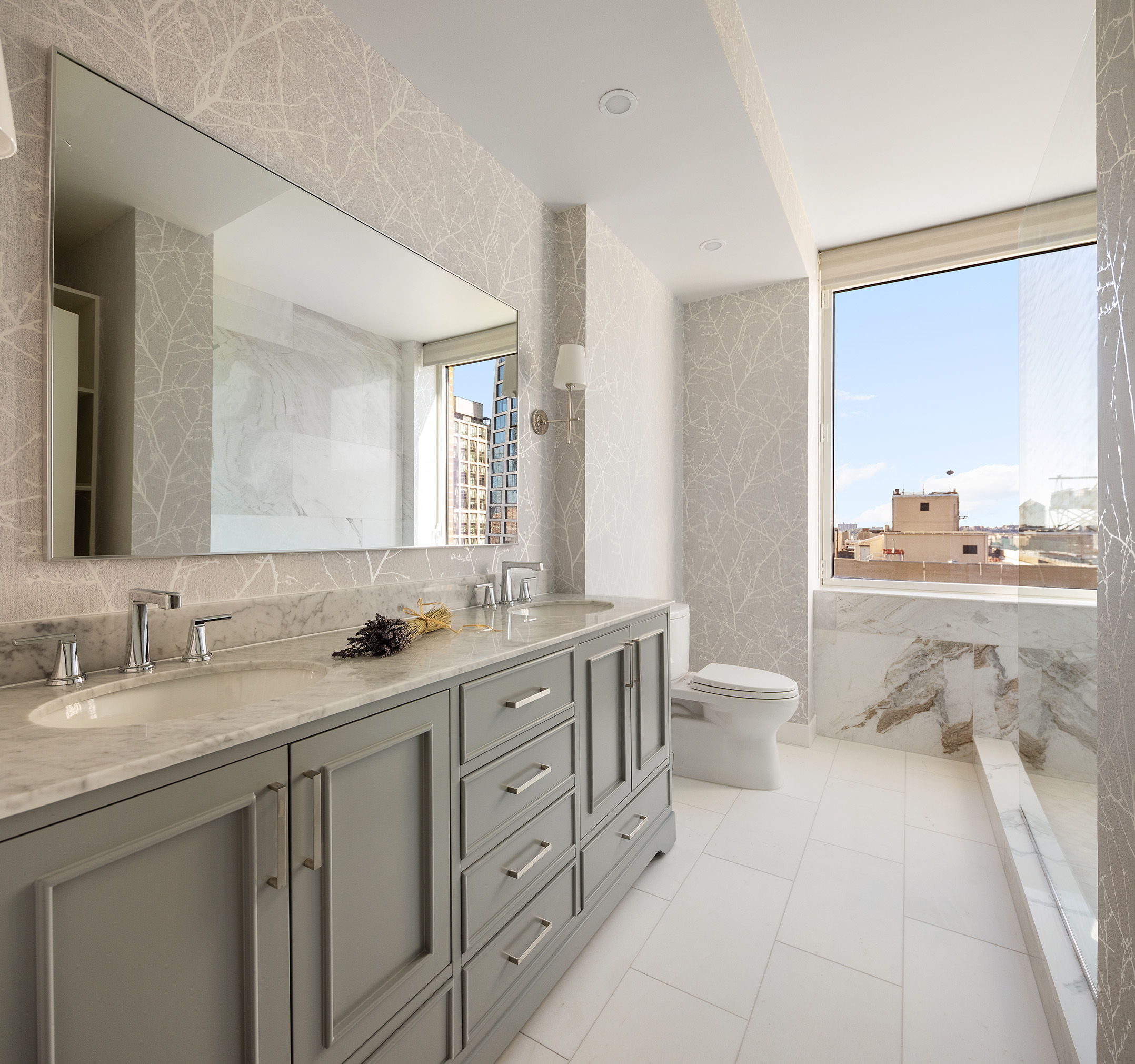 450 West 17th Street, Unit 1709 Manhattan, NY 10011 - Photo 11 of 27 a bathroom with a double vanity sink toilet mirror and bathtub