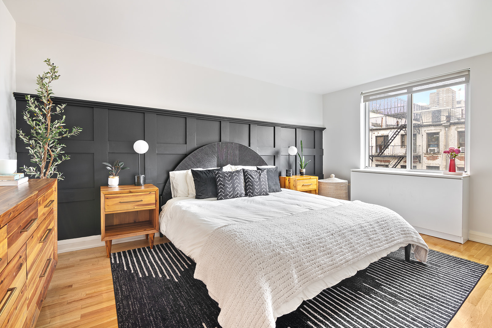 447 West 45th Street, Unit 5A Manhattan, NY 10036 - Photo 5 of 12 a bedroom with a bed and a chandelier