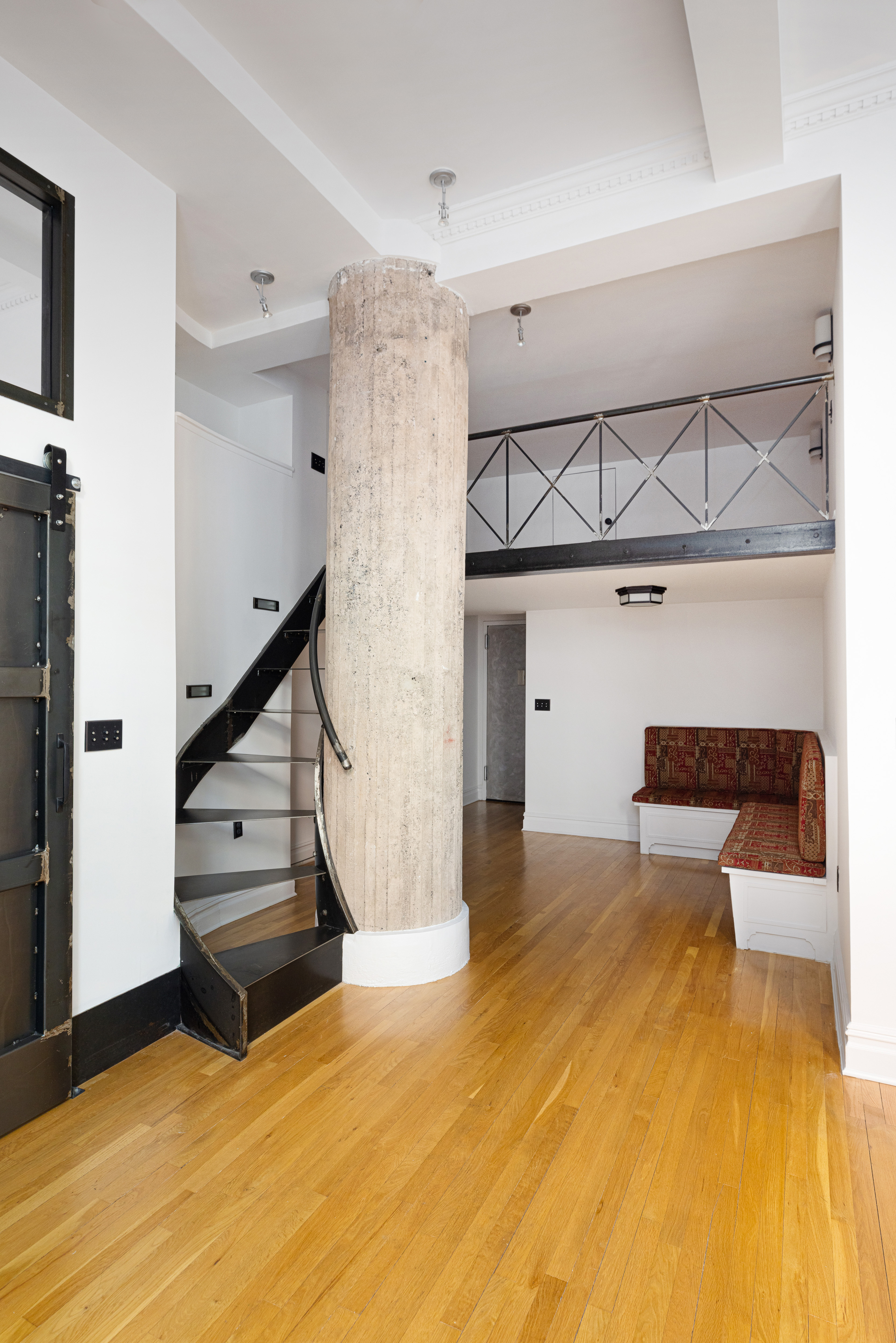 250 Mercer Street, Unit B203 Manhattan, NY 10012 - Photo 12 of 19 a view of a livingroom with wooden floor and stairs