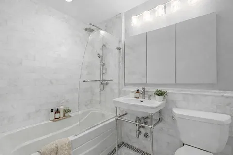 a bathroom with a sink a toilet and bathtub