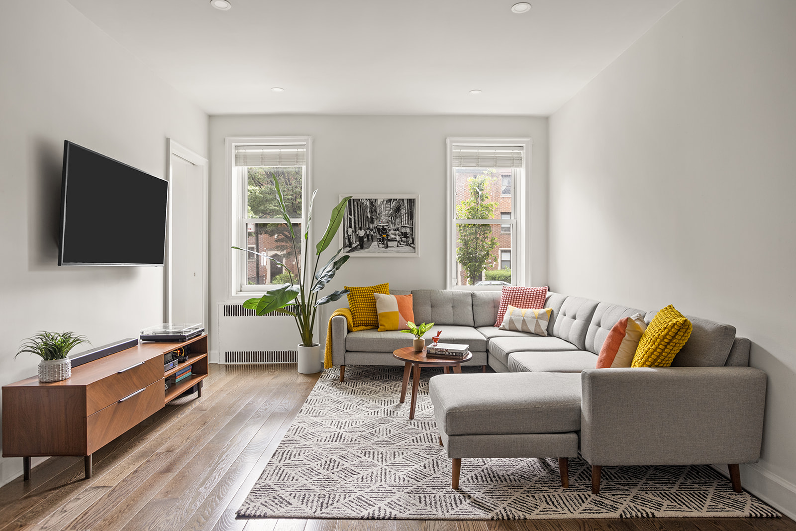 a living room with furniture and a flat screen tv