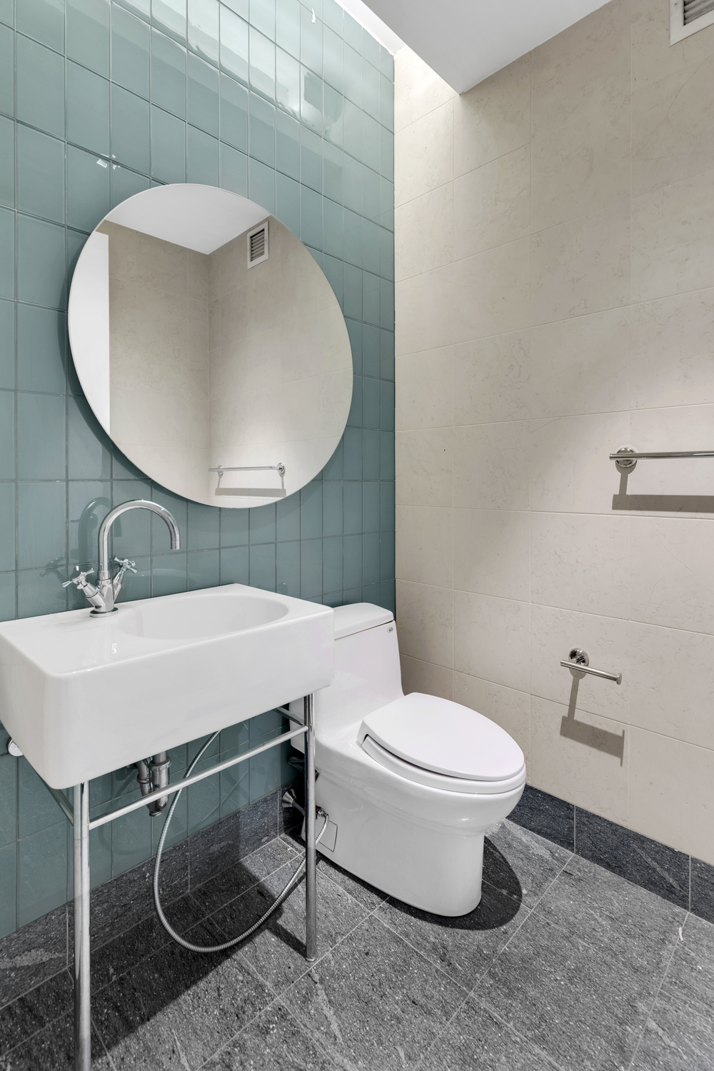 300 East 55th Street, Unit 28B Manhattan, NY 10022 - Photo 3 of 12 a bathroom with a sink toilet and mirror