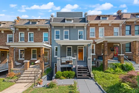 a front view of a residential apartment building with a yard