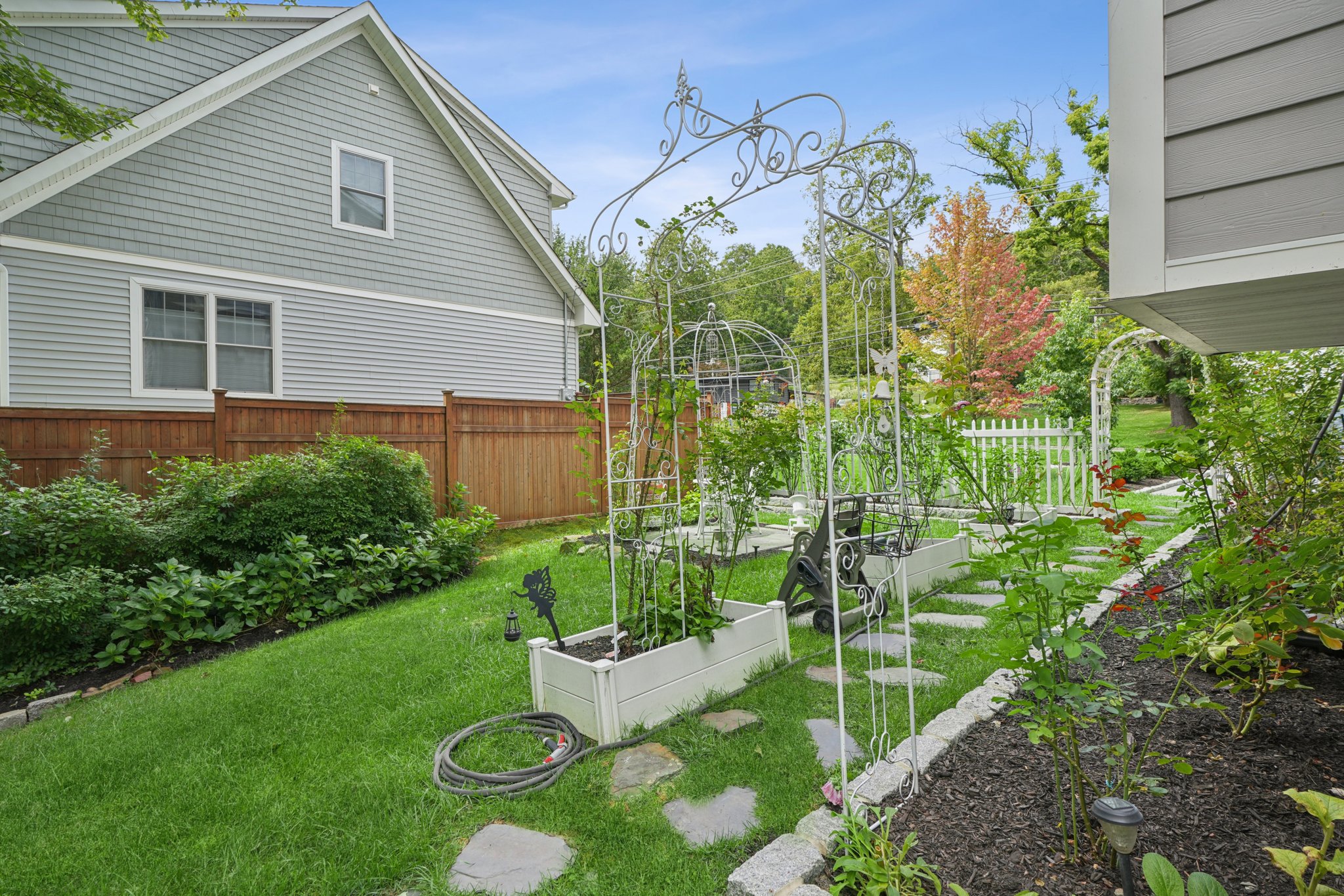 823 River Road Chatham, NJ 07928 - Photo 48 of 60 a view of backyard with table and chairs and potted plants