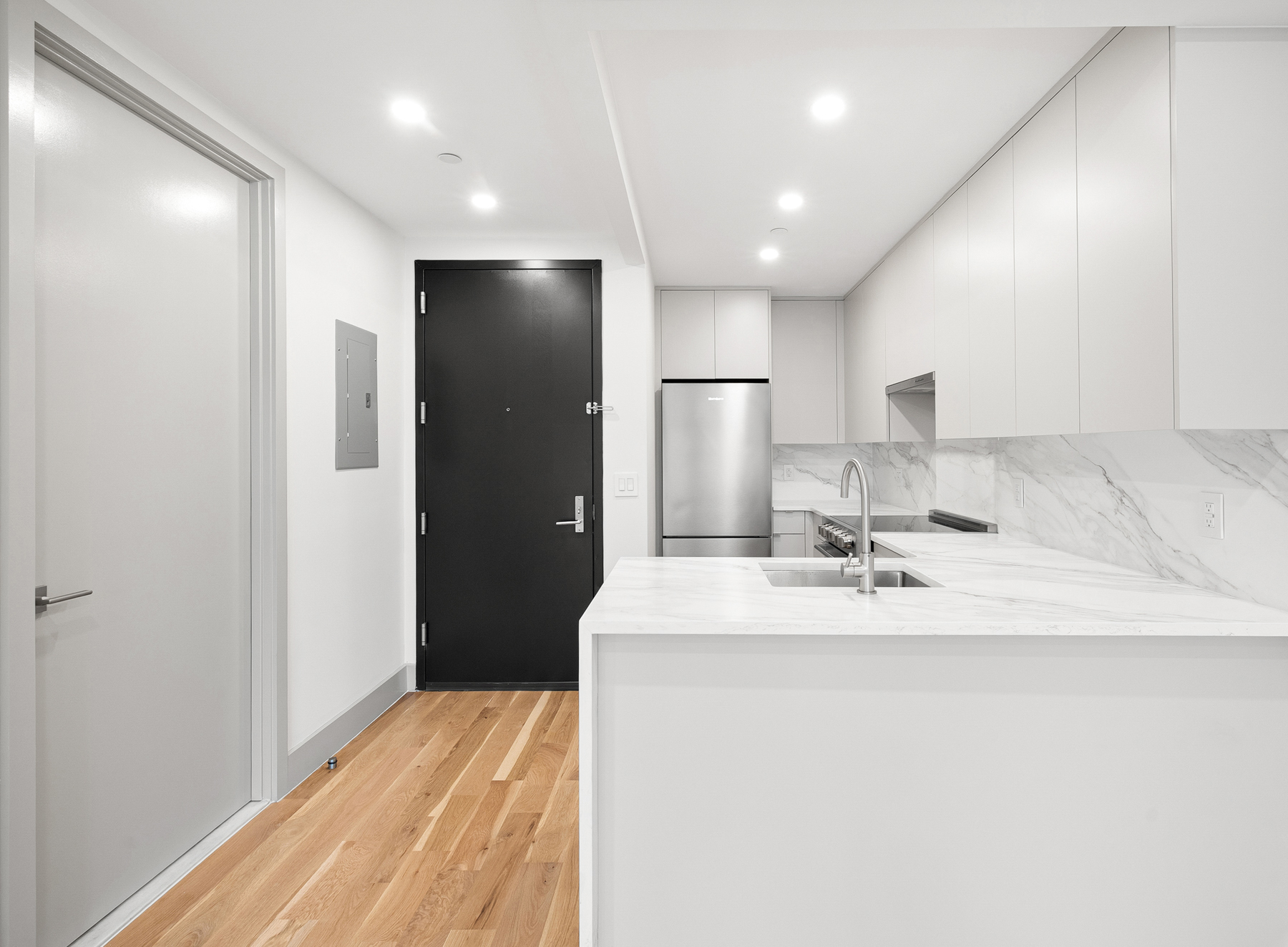 1155 Bedford Avenue, Unit 3F Brooklyn, NY 11216 - Photo 5 of 12 a room with a sink a refrigerator and a mirror