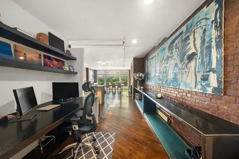 a kitchen with stainless steel appliances kitchen island granite countertop a stove and a view of living room